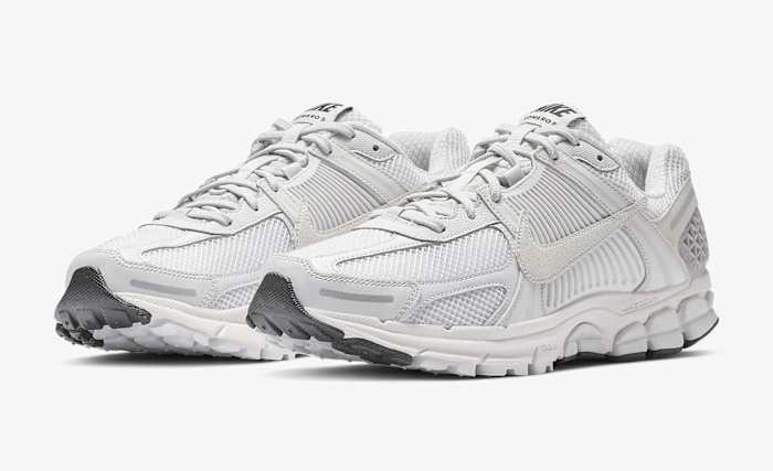 Side view of white and grey Nike sneakers.